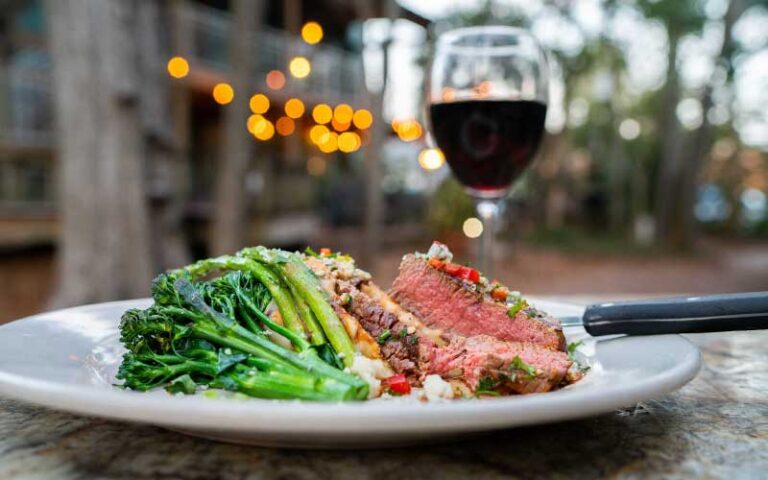 steak entree with broccoli and wine at cafe karibo fernandina beach amelia island