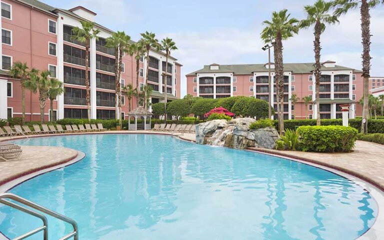 swimming pool with cascade and hotel buildings at caribe royale orlando