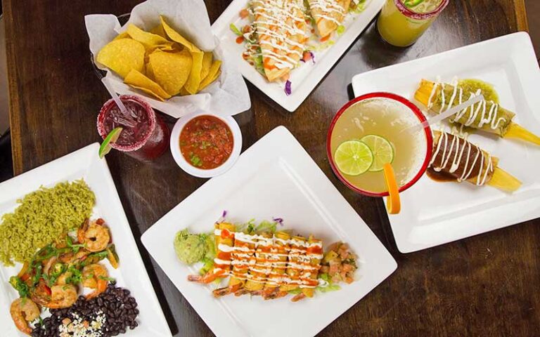 tabletop with latin cuisine entrees and drinks at peppers cocina mexicana tequila bar fernandina beach