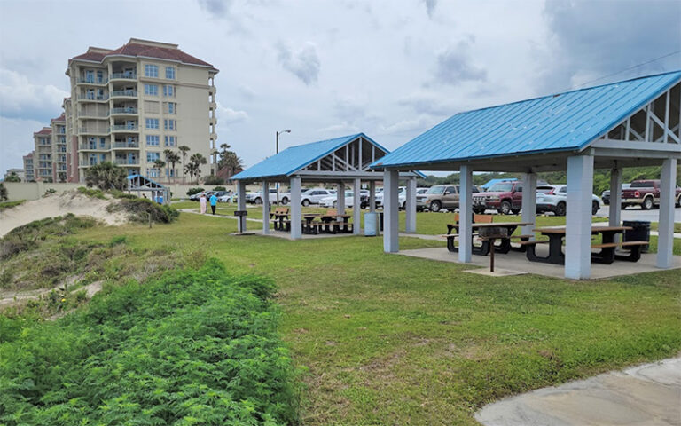 two picnic pavilions on beach with dunes and condo buildings at peters point beachfront park amelia island