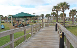 view from boardwalk of playground and park area at main beach park fernandina amelia island