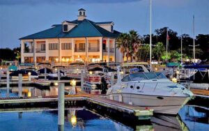 view from water of marina with boats and lighted building at dusk at crabby bills st cloud kissimmee