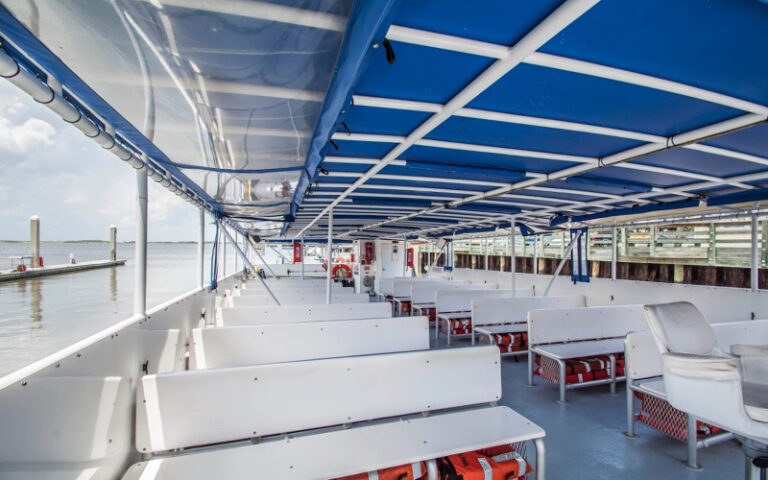 viewing deck of tour boat with seating and canopy at amelia river cruises charters fernandina beach