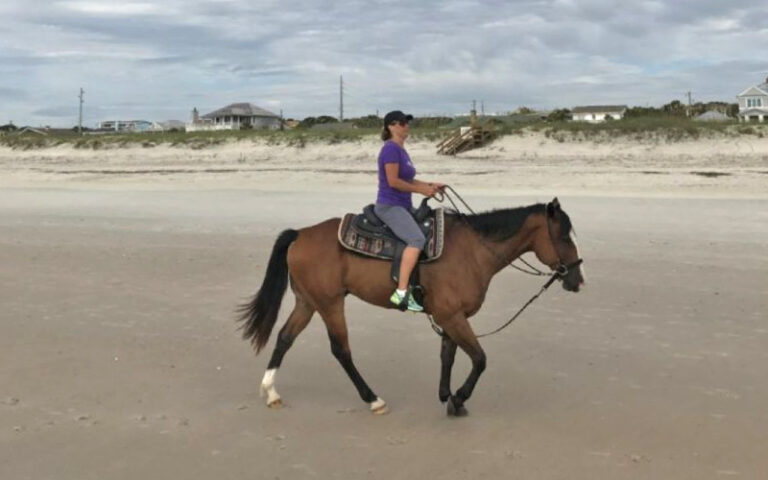 woman on horseback riding along beach at amelia island horseback riding