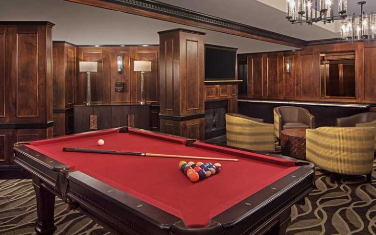 wood paneled lounge with red pool table at hotel duval autograph collection tallahassee