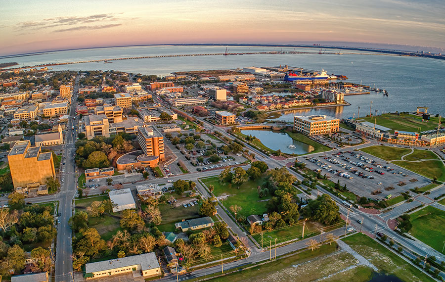 aerial view of pensacola at dusk with downtown bay and bridge