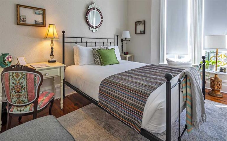 bedroom with period furnishings and sunlight from window at seven sisters ocala