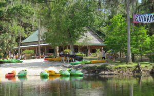 building along water with kayaks on bank at shingle creek regional park steffee landing kissimmee