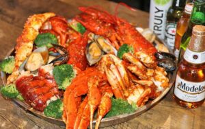 combo platter of seafood boil with beer bottles at storming crab ocala