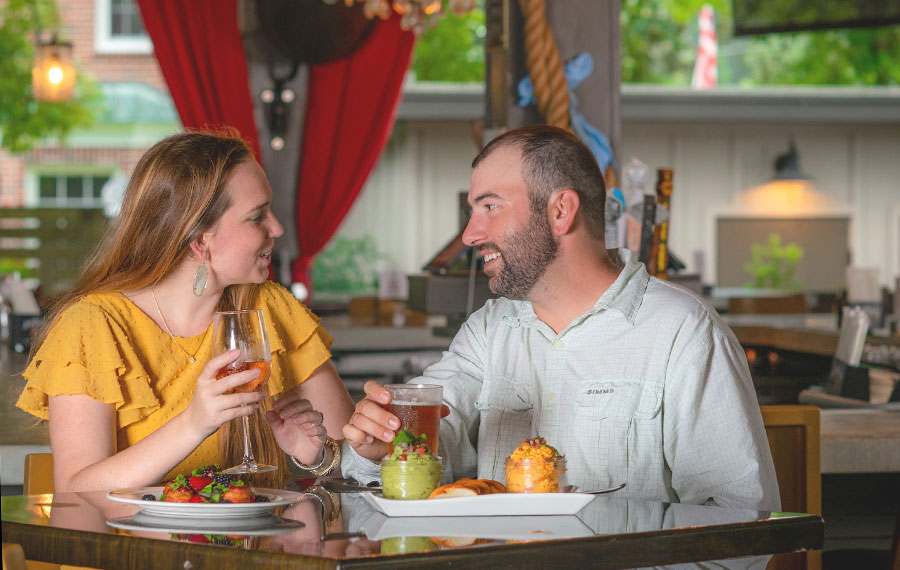 couple enjoying a meal at dining table in restaurant with chandelier at table 23 tallahassee