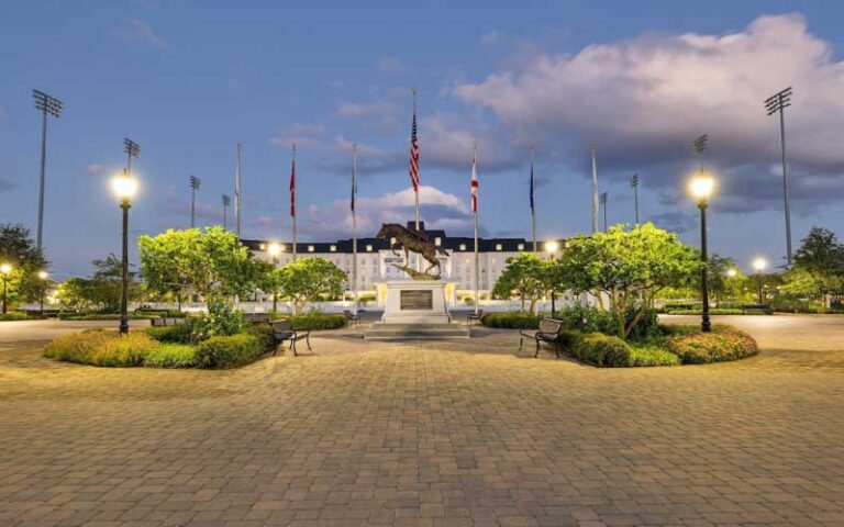 courtyard at twilight with horse statue and flags at world equestrian center ocala