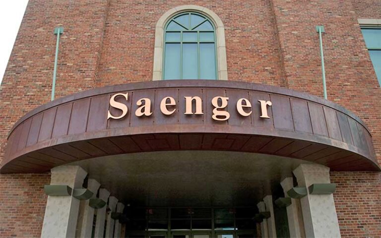 daytime exterior of brick building with sign over entrance at saenger theatre pensacola