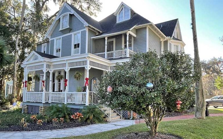 daytime exterior of house with yard and trees at seven sisters ocala