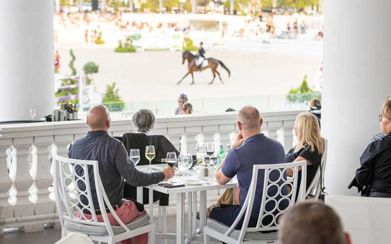 diners at table on veranda watching equestrian event at stirrups restaurant ocala