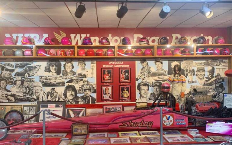 exhibit of red vehicle and helmets at don garlits museum of drag racing ocala