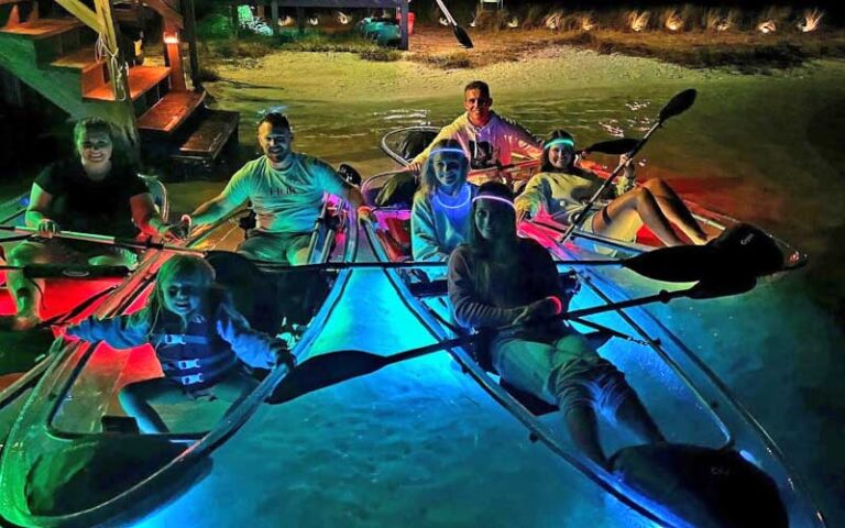 family group in kayaks at bank launching tour at glow paddle pensacola beach