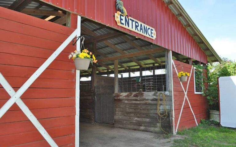 front exterior of red barn with entrance sign at petting zoo ocala