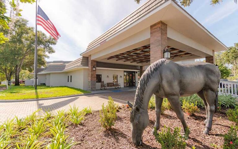 front exterior of hotel with horse sculpture at equus inn ocala