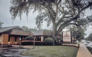 front exterior street view of restaurant with oak tree at braised onion ocala