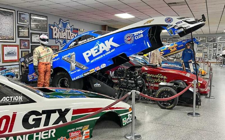 funny car displayed open with cars and uniforms at don garlits museum of drag racing ocala