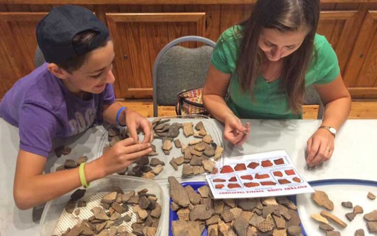 kids sorting through minerals on table inside museum area at oakland nature preserve winter garden orlando