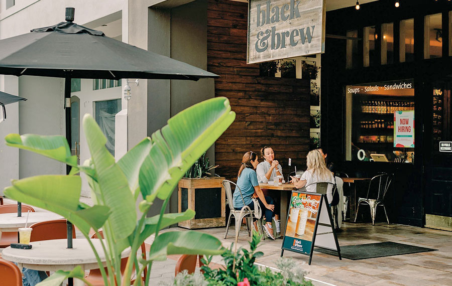 ladies dining at patio table in alcove along sidewalk at black brew lakeland