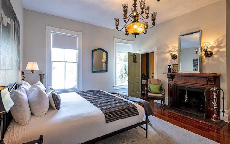 large bedroom with chandelier and period furnishings at seven sisters ocala