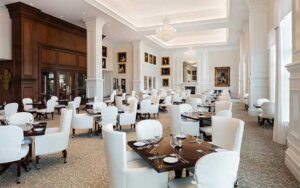 large dining area with white decor wood accents and portraits at stirrups restaurant ocala