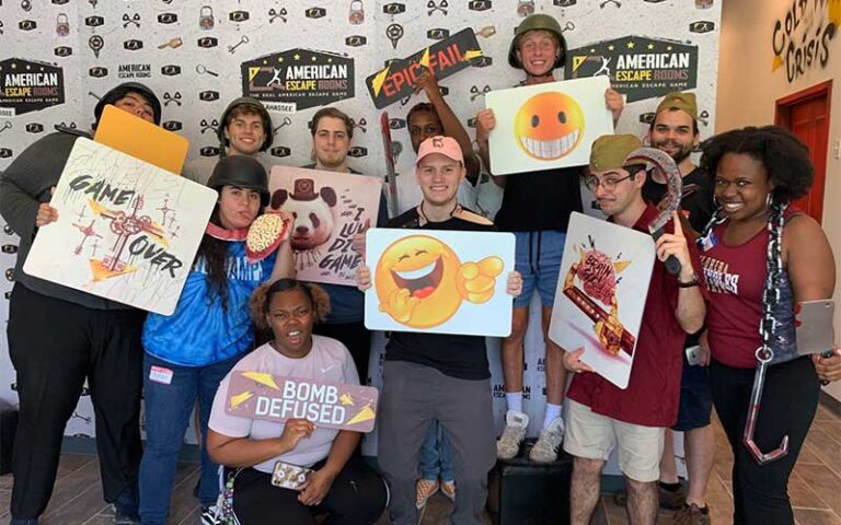 large group with signs after challenge at american escape rooms tallahassee