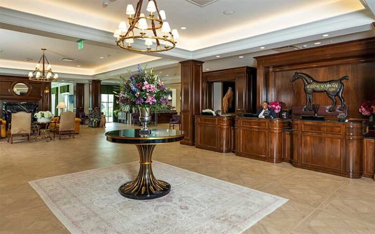 lobby with wood desk and chandelier at the riding academy hotel ocala