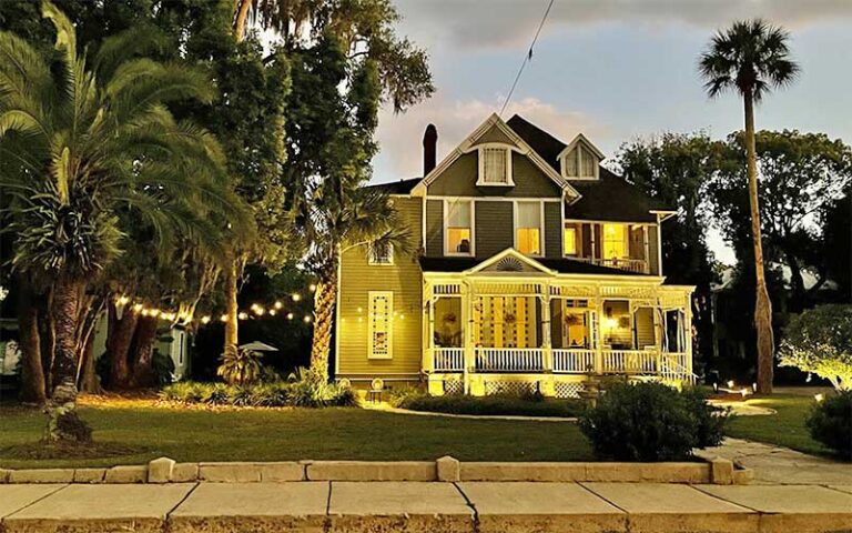 night view of lighted house from street at seven sisters ocala