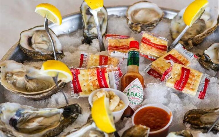 oysters platter on ice with tabasco bottle at storming crab ocala