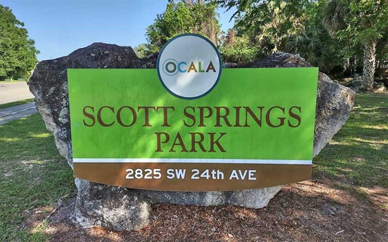 park sign on boulder at entrance along road at scott springs park ocala