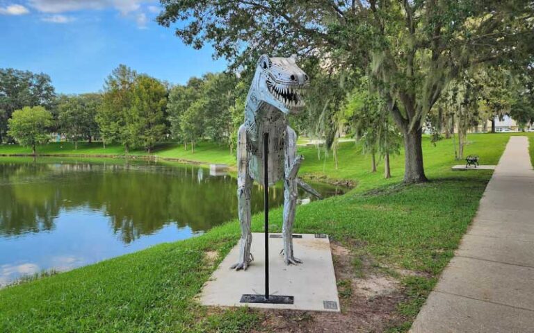 park with lake and dinosaur sculpture at tuscawilla park ocala