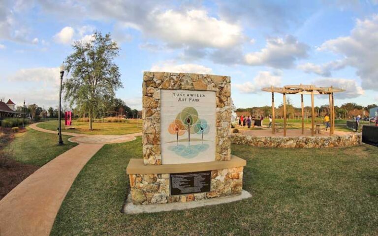 park with stone sign and pathways at tuscawilla park ocala