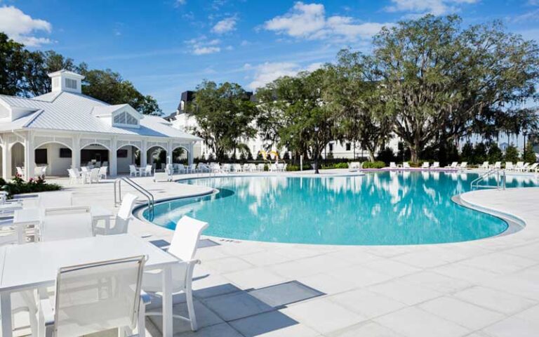 pool area with clubhouse and seating at the equestrian hotel ocala