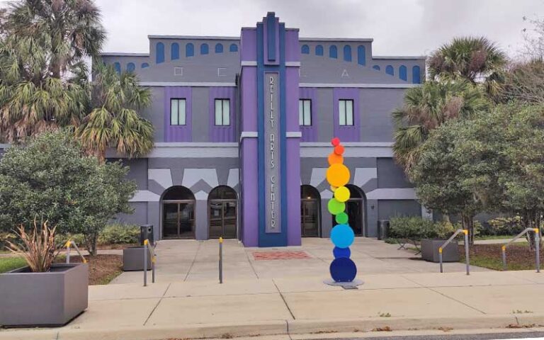 purple theater building with art sculpture at tuscawilla park ocala