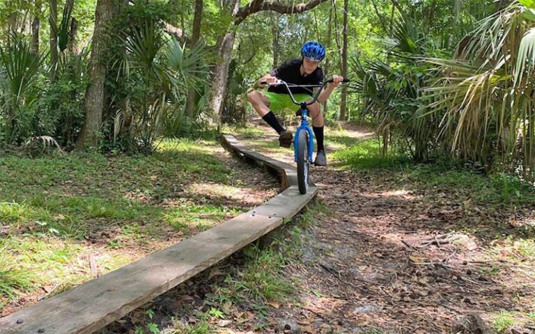 raised board track terrain course with kid riding bike at scott springs park ocala