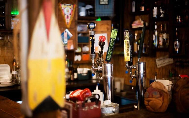 row of craft beer taps at bar at brooklyns backyard ocala