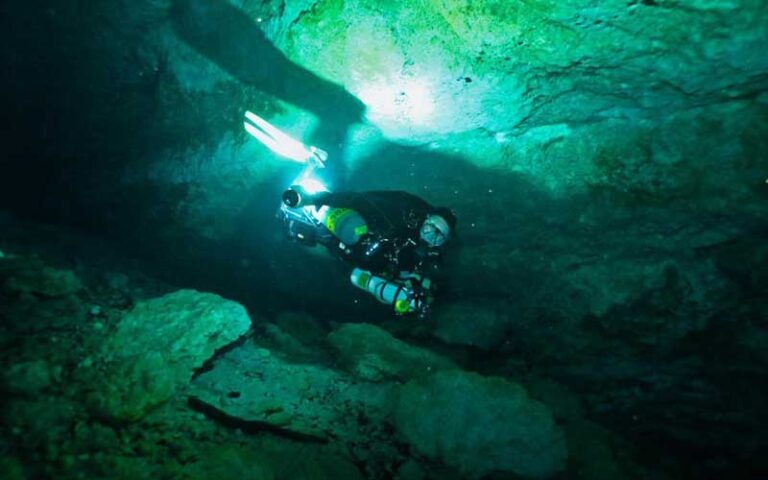 scuba diver in underwater cave passage at paradise springs ocala