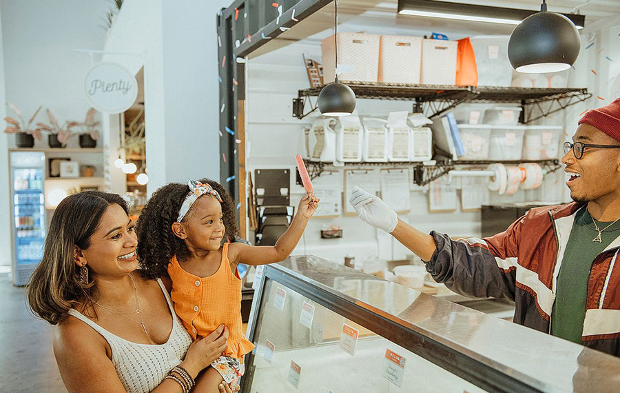 server handing little girl with mom popsicle the joinery lakeland