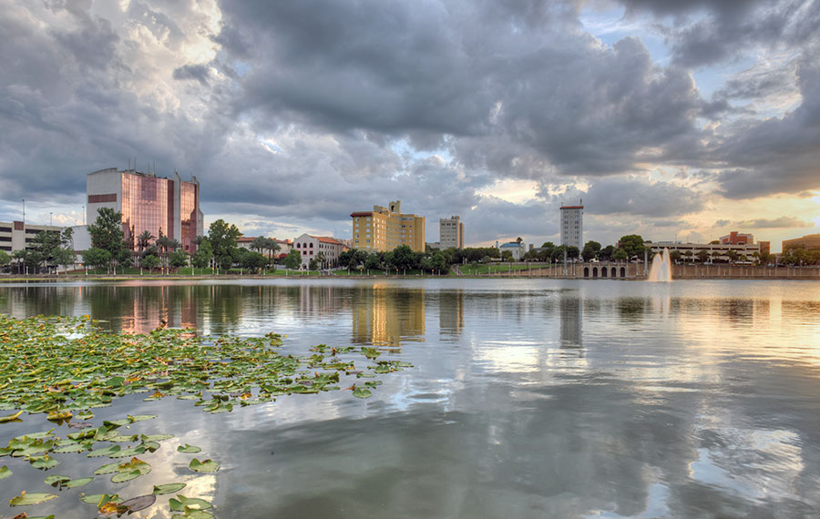 skyline along lake mirror with dark clouds in lakeland florida