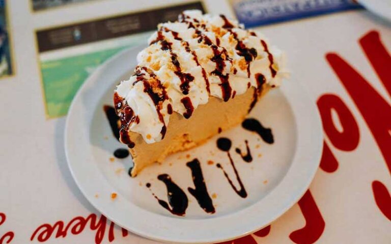 slice of pie with whipped topping and syrup at wolfys restaurant ocala