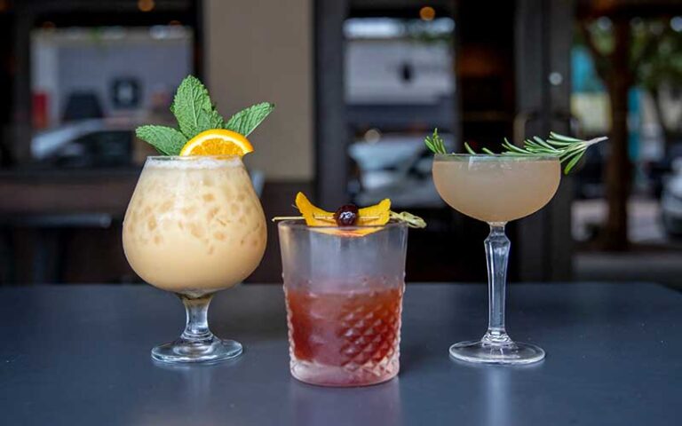 three different cocktails along bar at brick city southern kitchen ocala