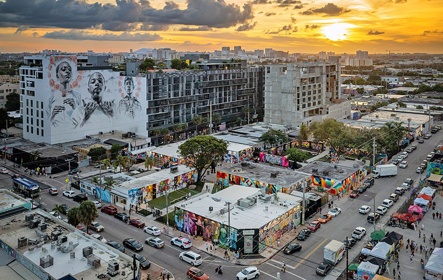 twilight aerial view of city blocks with art murals at wynwood walls miami