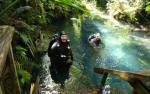 two scuba divers emerging from water at paradise springs ocala