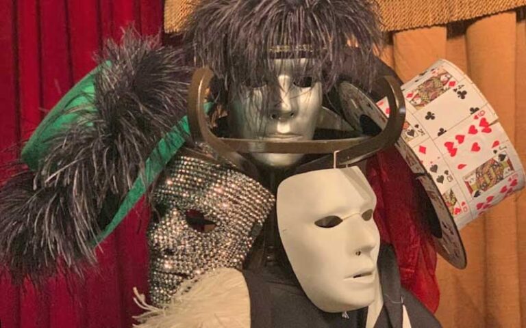 coat rack with masks and hats for selfies at theatre magic st augustine