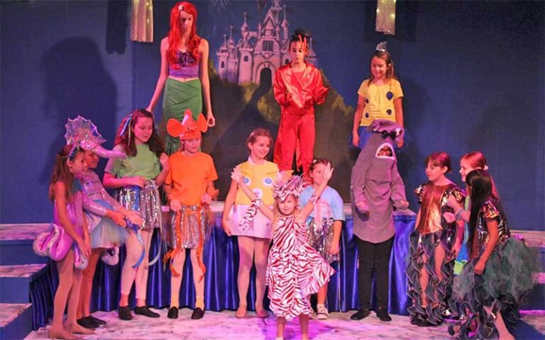 costumed children singing on stage at limelight theatre st augustine