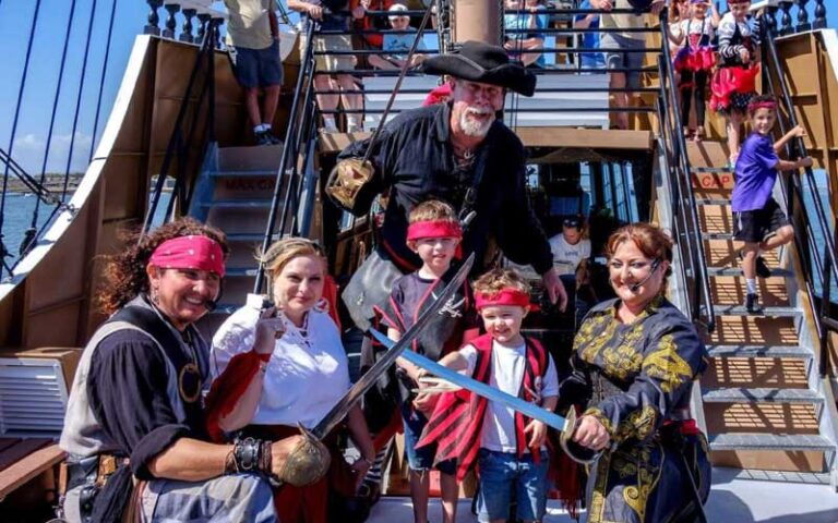 crew of pirates posing on deck at black raven pirate ship st augustine