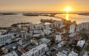 downtown skyline along bay with bridge barrier islands and sunset sarasota